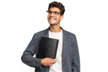 Young teacher caucasian man holding a book isolated dreaming of achieving goals and purposes