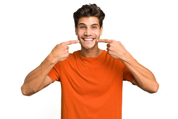 Young caucasian handsome man isolated smiles, pointing fingers at mouth.