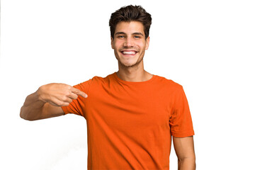 Young caucasian handsome man isolated person pointing by hand to a shirt copy space, proud and confident