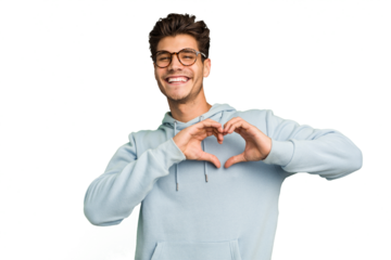 Young caucasian handsome man isolated smiling and showing a heart shape with hands.