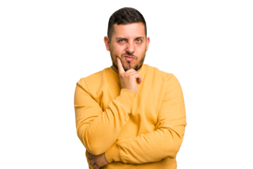 Young caucasian man isolated contemplating, planning a strategy, thinking about the way of a business.