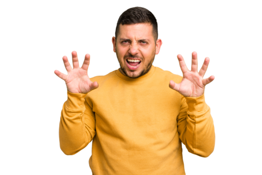 Young caucasian man isolated showing claws imitating a cat, aggressive gesture.