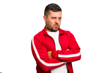 Young caucasian man isolated suspicious, uncertain, examining you.