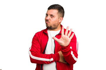 Young caucasian man isolated rejecting someone showing a gesture of disgust.