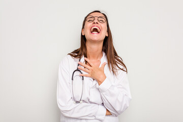 Young doctor woman isolated on white background laughs out loudly keeping hand on chest.