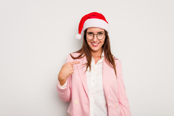 Business caucasian woman wearing a christmas hat isolated on white background person pointing by hand to a shirt copy space, proud and confident