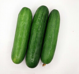 Green cucumbers, isolated on a white background. A fresh vegetable photography