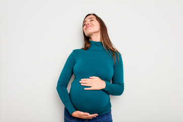 Pregnant caucasian woman isolated on white background dreaming of achieving goals and purposes