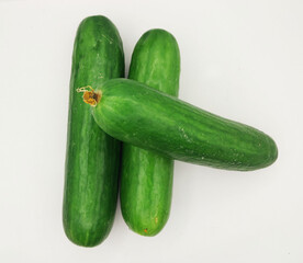 Green cucumbers, isolated on a white background. A fresh vegetable photography