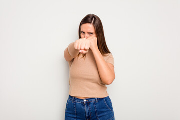 Young caucasian cute woman isolated on white background throwing a punch, anger, fighting due to an argument, boxing.