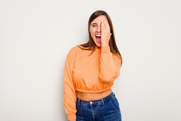 Young caucasian cute woman isolated on white background having fun covering half of face with palm.