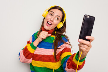 Young caucasian woman using her mobile phone for a video call isolated