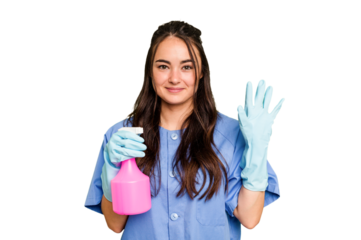 Young cleaner caucasian woman isolated on green chroma background smiling cheerful showing number five with fingers.