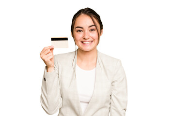 Young caucasian woman holding a credit card isolated on green chroma background happy, smiling and...