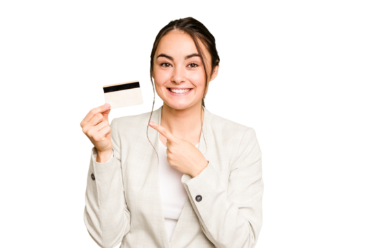 Young caucasian woman holding a credit card isolated on green chroma background smiling and pointing aside, showing something at blank space. - Powered by Adobe