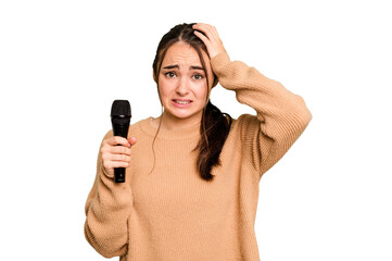 Young caucasian singer woman isolated on green chroma background being shocked, she has remembered...