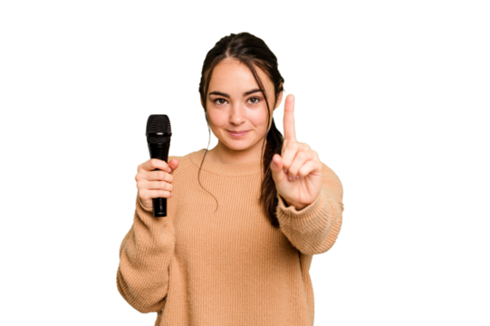 Young caucasian singer woman isolated on green chroma background showing number one with finger.