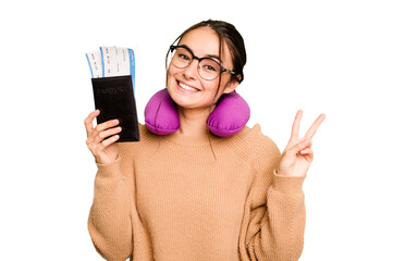 Young caucasian woman with inflatable travel pillow holding passport isolated on green chroma...