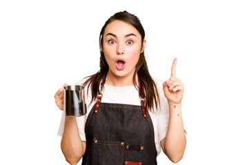 Young barista woman isolated on green chroma background having an idea, inspiration concept.