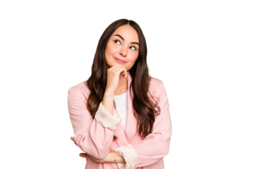 Young caucasian woman isolated on green chroma background relaxed thinking about something looking at a copy space.