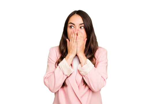 Young caucasian woman isolated on green chroma background thoughtful looking to a copy space covering mouth with hand.