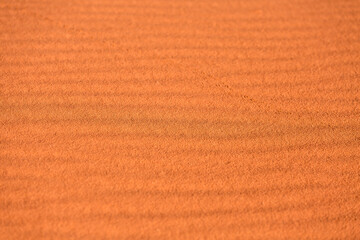 Gold orange desert sand texture background with waves and traces