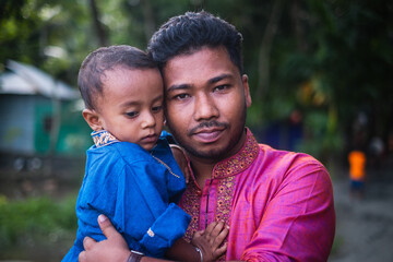 South asian father and son in colourful traditional dress 