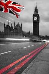 Fototapeta na wymiar Big Ben during a evening with lights of cars anf flag of England in London, United Kingdom