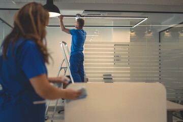 Cleaners do general cleaning of office premises - Powered by Adobe