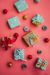 Small Christmas gifts on pink background