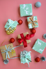 Small Christmas gifts on pink background