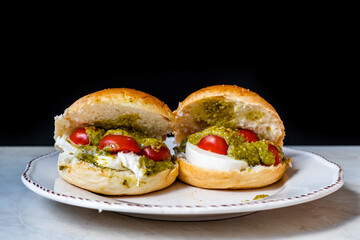 Italian Caprese sandwiches with fresh cherry  tomatoes, mozzarella cheese and pesto sauce.