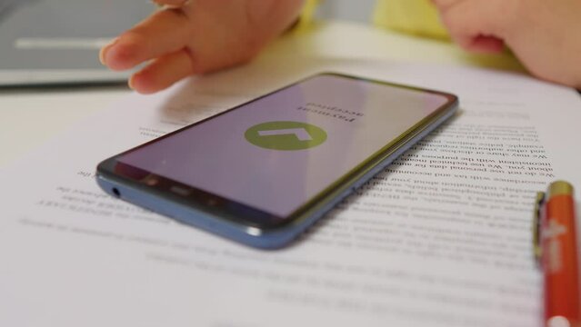Close-up hand and phone successfully paying online purchase. Nervous tapping waiting for online pay confirmation.
