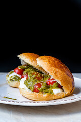 Italian Caprese sandwiches with fresh cherry  tomatoes, mozzarella cheese and pesto sauce.