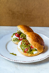 Italian Caprese sandwiches with fresh cherry  tomatoes, mozzarella cheese and pesto sauce.
