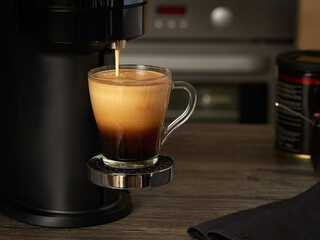 Closeup of a glass cup with freshly brewed coffee