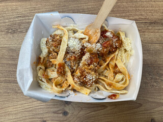Take Away Spaghetti Bolognese with Parmesan Cheese. Take Out.