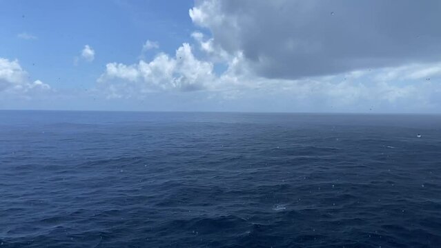 Rainy day in the atlantic ocean. Time lapse filming of the rain. calm ocean. Beautiful sky in the open sea. clear blue water