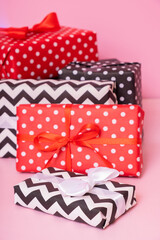 Merry Christmas, New year and sale event concept. Gift boxes with ribbon bow on pink background