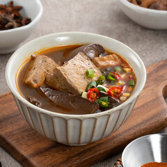 Spicy duck blood jelly soup and stinky tofu with scallion and chili pepper topping.