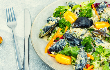 Yummy vegetable salad with seafood.