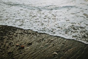 Sea foam from the waves on the shore