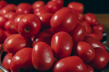 The Roma tomato or Roma is a plum tomato popularly used both for canning and producing tomato paste because of its slender and firm nature. Selective Focus pile of tomatoes.