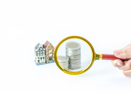 Inspecting money coin stack for made house.