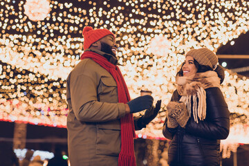 Portrait of attractive cheerful couple friends friendship visiting international festal fair sale talking drinking latte city urban outdoors