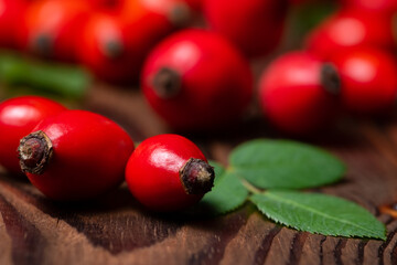 ripe red dogrose on a wooden background