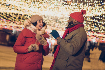 Portrait of two affectionate cheerful people having fun wish dream countdown congrats December strolling outdoors