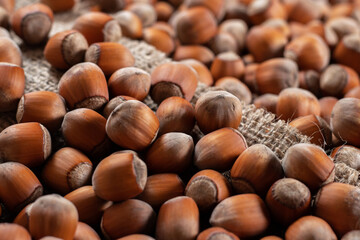 close up of hazelnuts on wooden table, top view