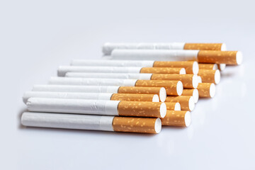 Close up of a smoking cigarettes. cigarette filter tubes on white