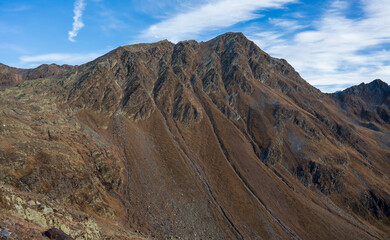 Peak and ridge of high rocky mountains with cliffs.